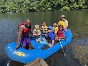 children enjoy time on a raft on a pond